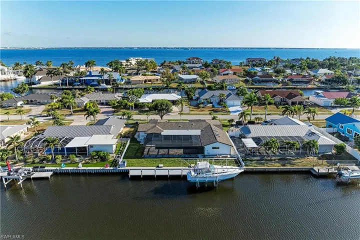 Aerial perspective of suburban area featuring a large body of water