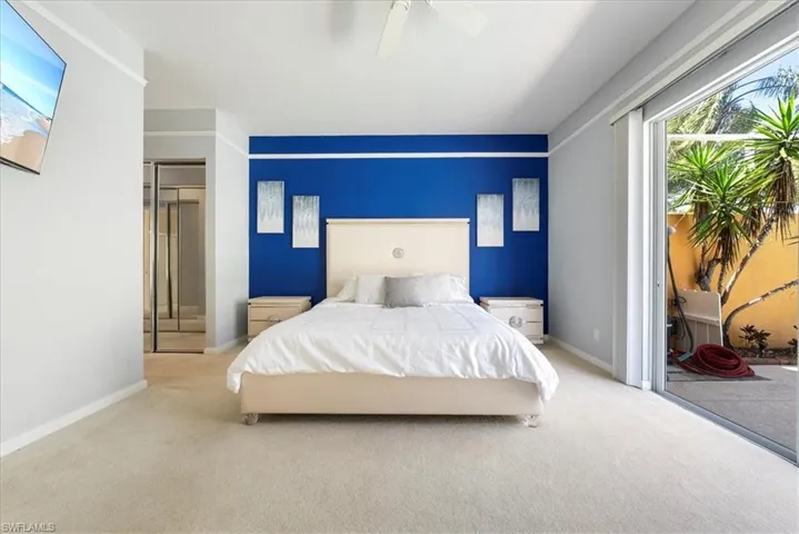 Bedroom with baseboards, carpet, and access to outside