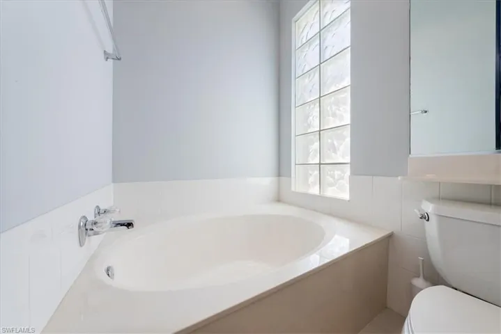 Full bath with toilet and a bath