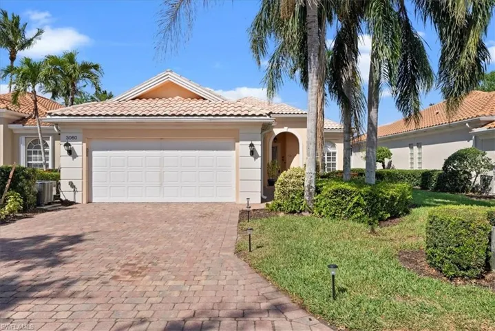 Mediterranean / spanish-style house featuring central air condition unit, stucco siding, an attached garage, a tiled roof, and decorative driveway