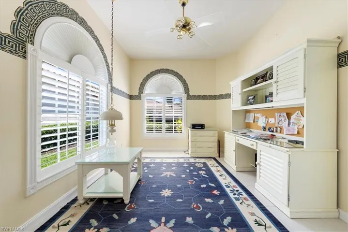 Kitchen with light countertops, baseboards, a ceiling fan, open shelves, and light tile patterned floors