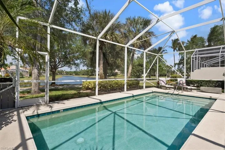 Pool featuring a lanai, a water view, and a patio