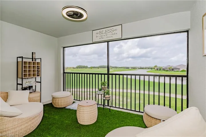 Sunroom / solarium featuring a water view