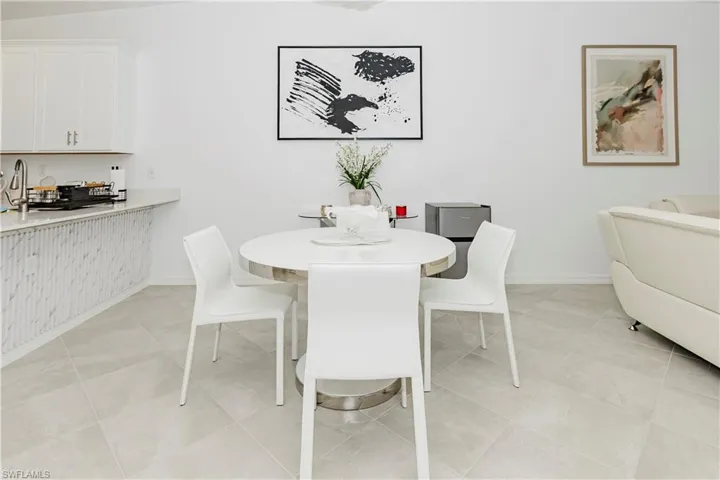 Dining area with baseboards and light tile patterned flooring