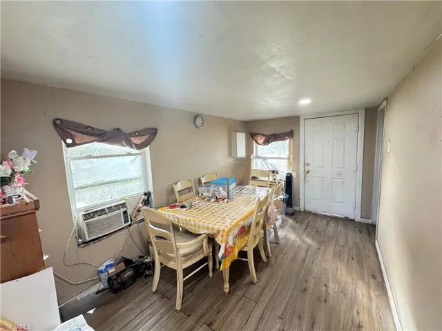 Dining space featuring wood finished floors and cooling unit