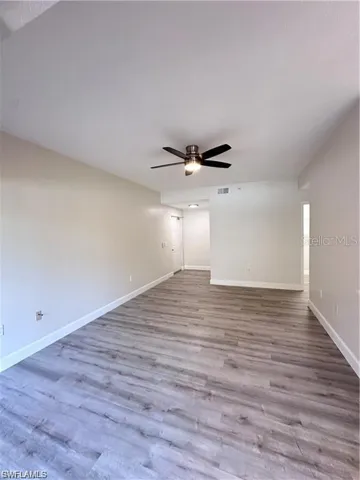 Spare room featuring light wood-type flooring and baseboards