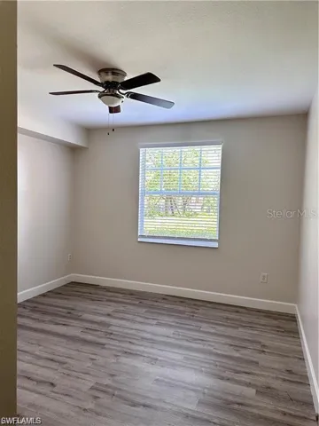 Unfurnished room with wood finished floors, a textured ceiling, and ceiling fan