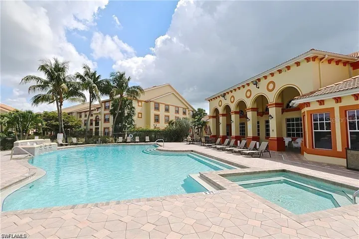 Community pool with a community hot tub and a patio area