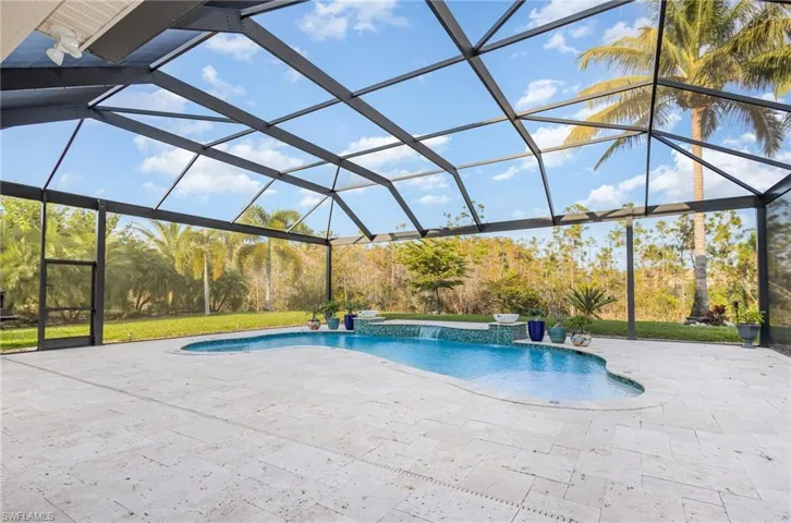 Swimming pool with glass enclosure, a sunroom, and a patio