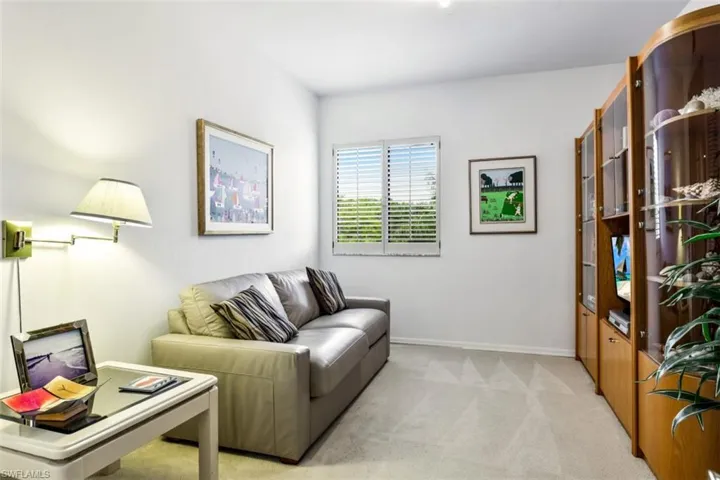 Living room with light colored carpet and baseboards