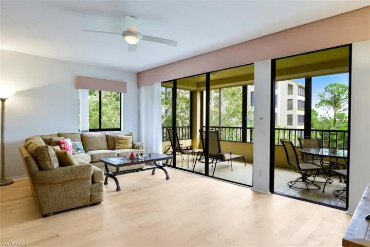 Living area with wood finished floors and a ceiling fan