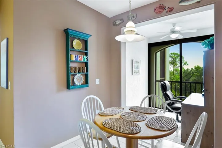 Tiled dining room featuring baseboards and ceiling fan