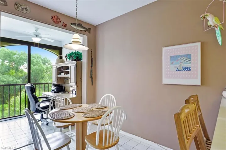 Dining area featuring light tile patterned flooring and ceiling fan