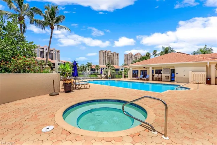 Community pool with a hot tub and a patio area