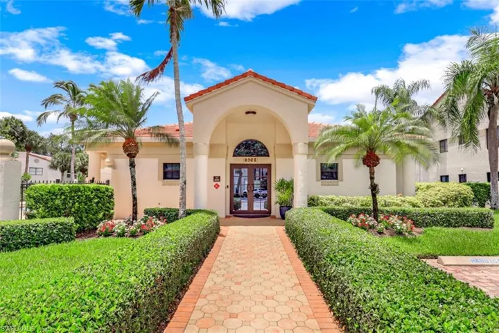 View of exterior entry featuring french doors, stucco siding, and a tiled roof