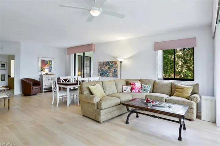 Living area with light wood-style flooring and ceiling fan