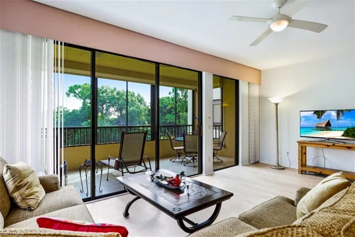 Living room with light wood-type flooring and ceiling fan