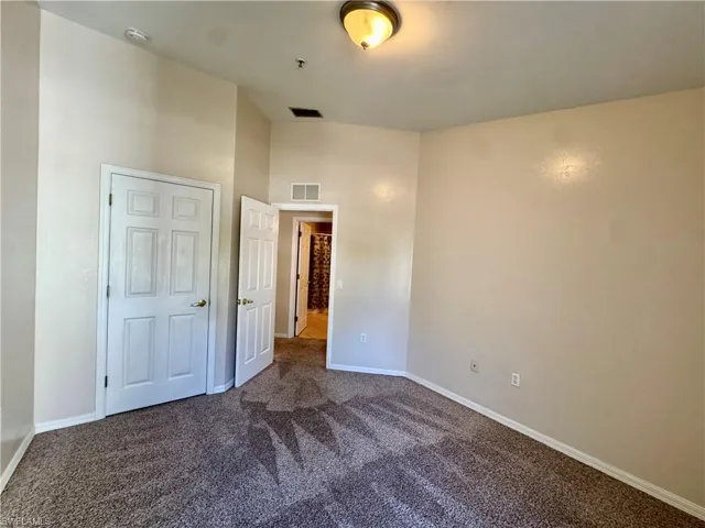 Unfurnished bedroom featuring carpet and baseboards
