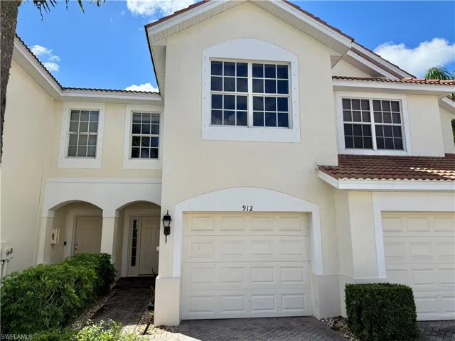 Mediterranean / spanish home featuring stucco siding, a tile roof, and an attached garage