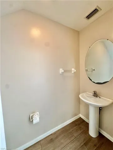 Bathroom with baseboards and wood finished floors