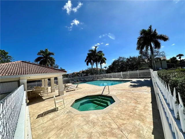 Community pool with a patio and a community hot tub