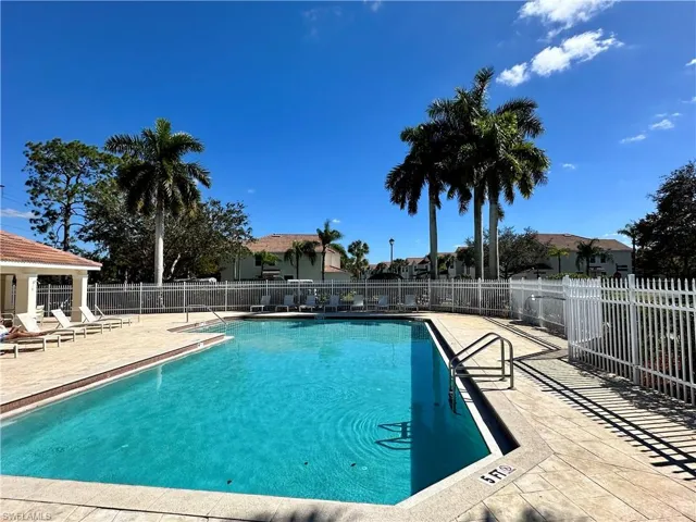 Community pool with a patio