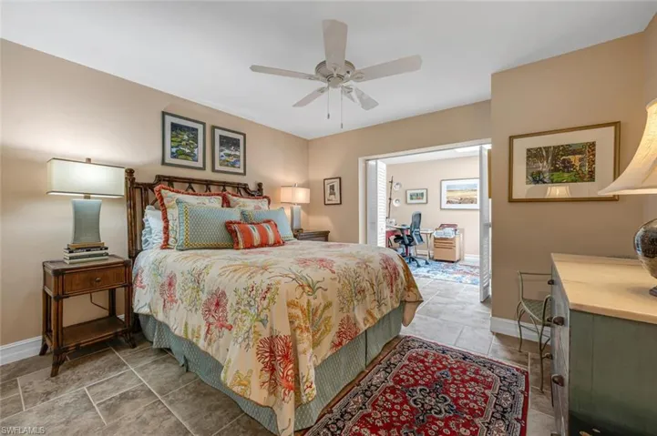 Bedroom with a ceiling fan and baseboards