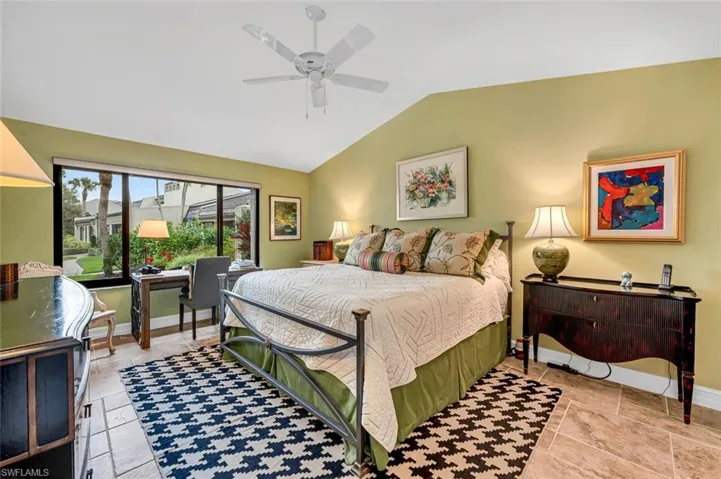 Bedroom featuring lofted ceiling, ceiling fan, and baseboards