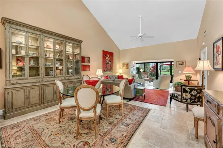 Dining space with high vaulted ceiling and a ceiling fan