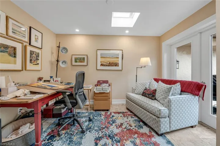 Tiled office space with a skylight, baseboards, and recessed lighting