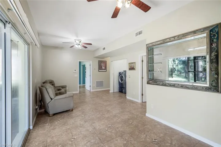 Sitting room featuring washer / dryer and ceiling fan