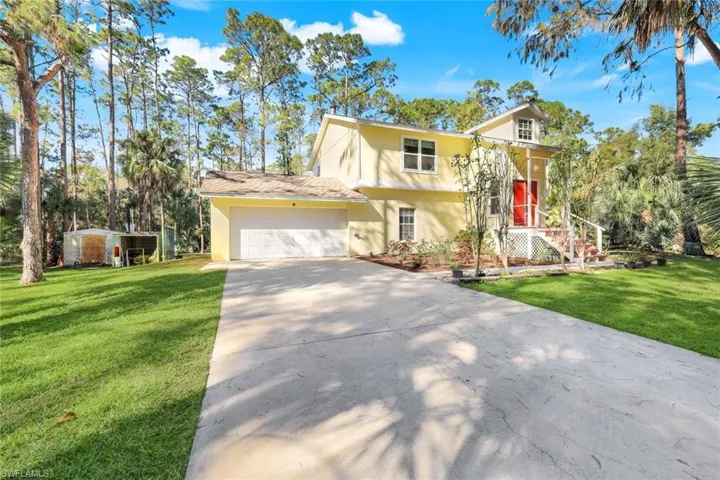 View of front of home featuring a garage and a front lawn