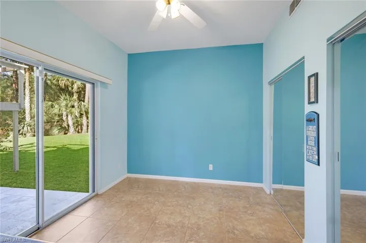 Unfurnished room with ceiling fan and light tile patterned floors