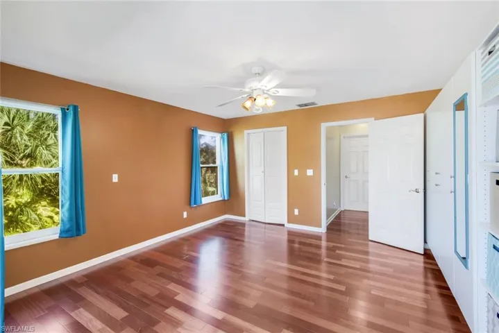 Unfurnished bedroom with hardwood / wood-style flooring and ceiling fan