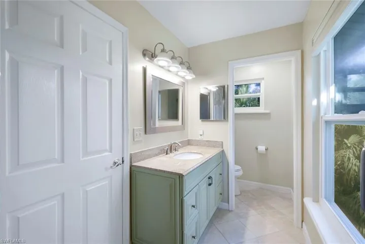 Bathroom with tile patterned floors, vanity, and toilet