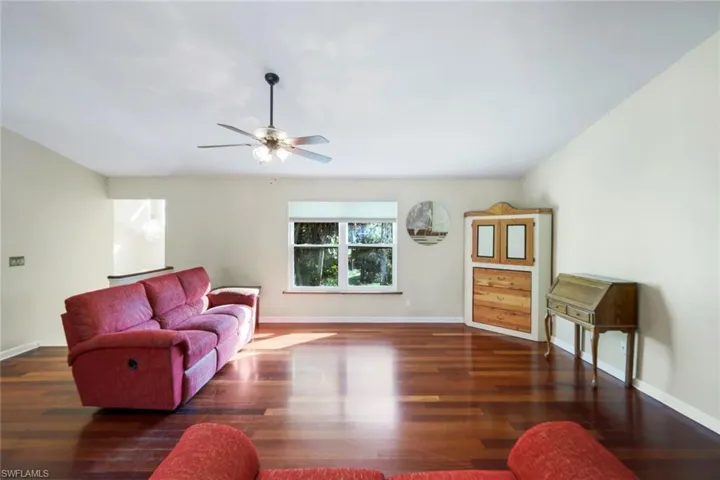 Living room featuring  hardwood / wood-style floors and ceiling fan