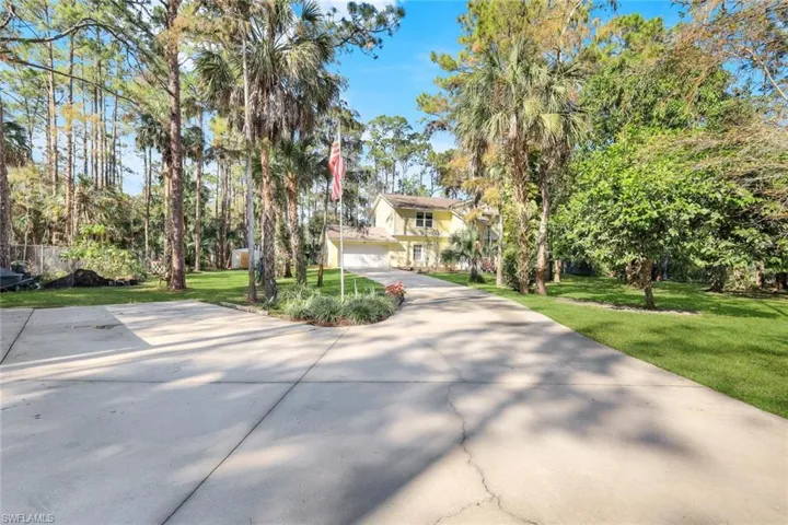 View of front of house with a garage and a front yard