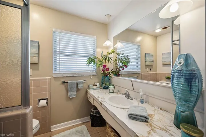 Bathroom with tile patterned floors, toilet, and vanity