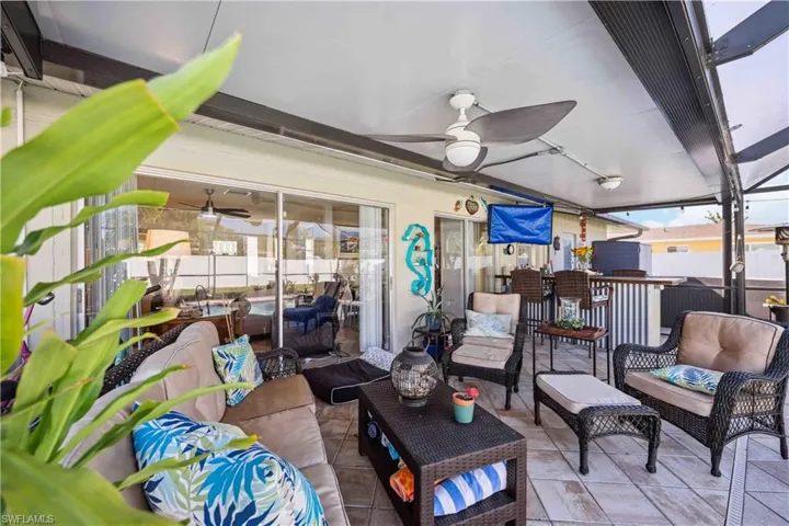 View of patio featuring an outdoor living space and ceiling fan