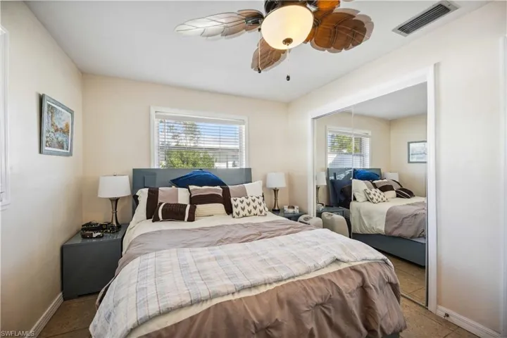 Bedroom with baseboards, a ceiling fan, and a closet