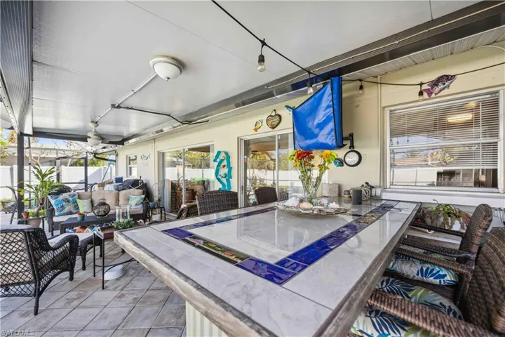 View of patio / terrace with an outdoor living space, outdoor dining area, fence, and ceiling fan