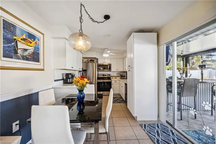 Dining area with a ceiling fan and light tile patterned floors
