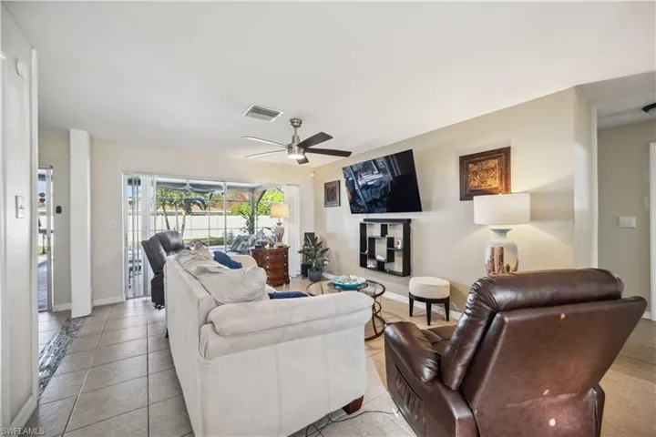 Living room with ceiling fan and baseboards