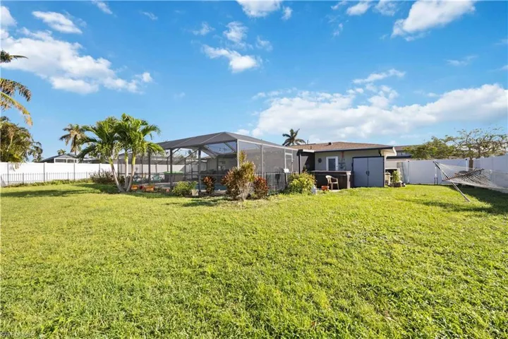 View of yard with a storage shed and a lanai