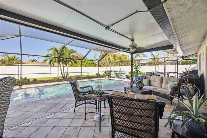 View of patio / terrace featuring a fenced backyard, outdoor lounge area, and glass enclosure