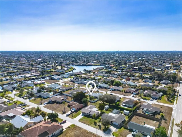 Aerial perspective of suburban area featuring a large body of water