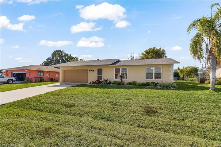Ranch-style house featuring stucco siding, concrete driveway, a garage, and a front yard