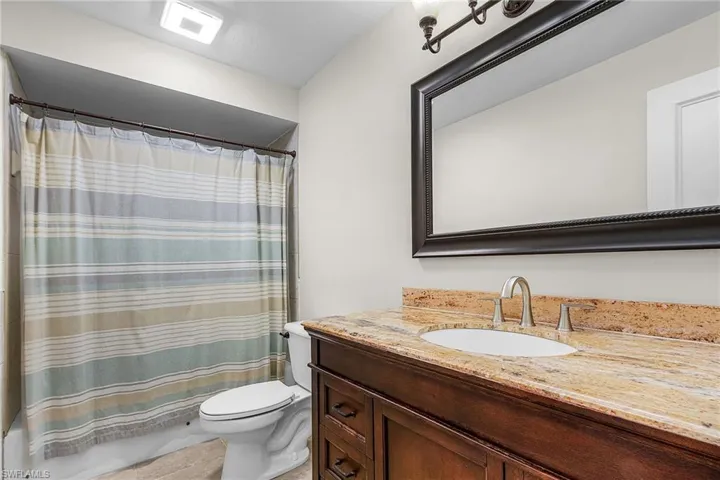 Full bath featuring vanity and toilet