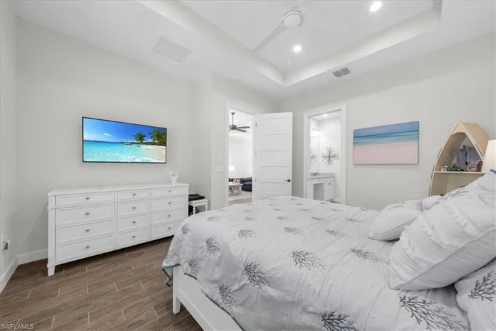 Bedroom with wood tiled floors, a closet, and ceiling fan