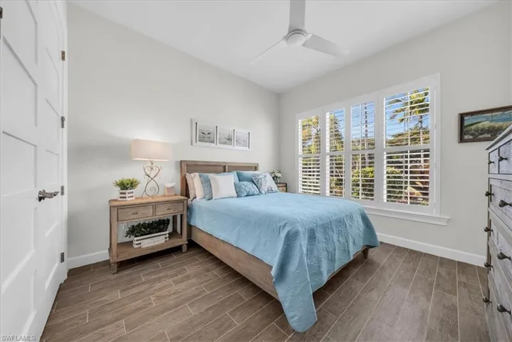 Bedroom with wood tiled floors and ceiling fan